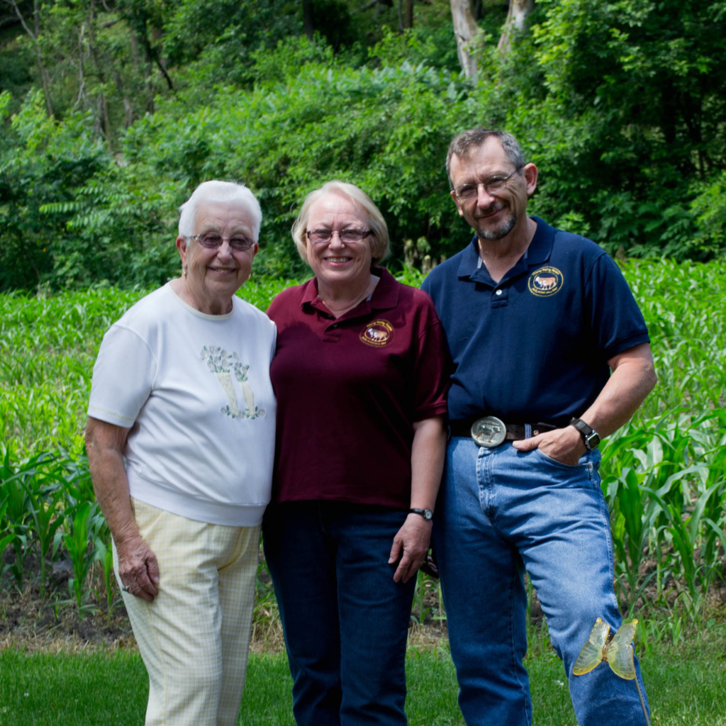 Three older adults smiling. 