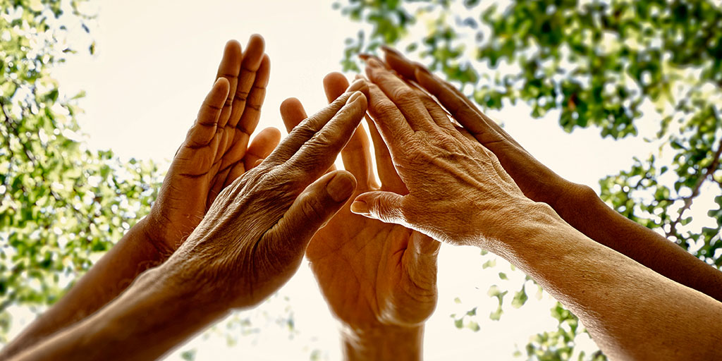 Elderly hands coming together